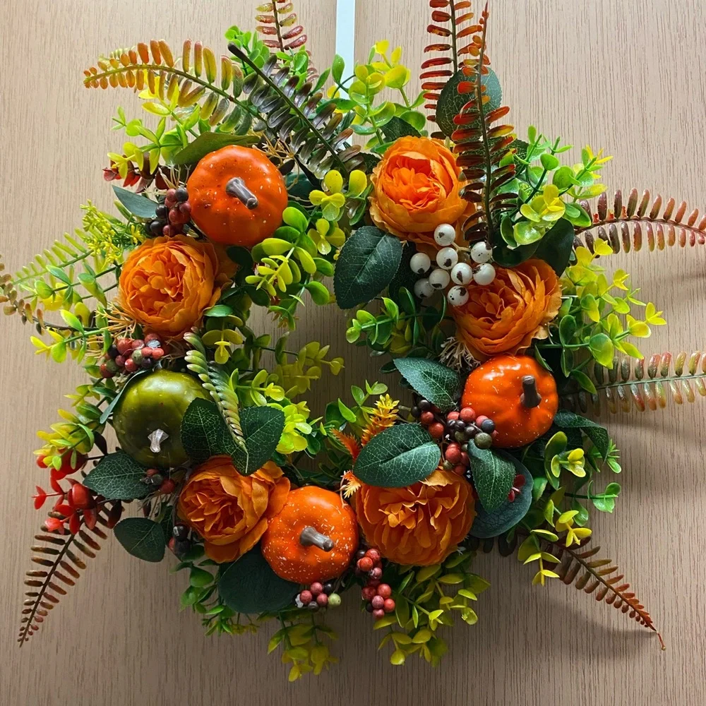 Two 12”x 12” round plastic wreaths; one fall wreath and one Christmas wreath.